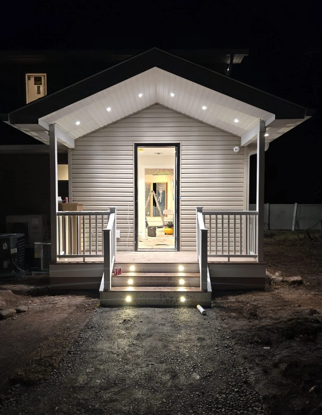 Residential entry illuminated with soffit and step lights at night