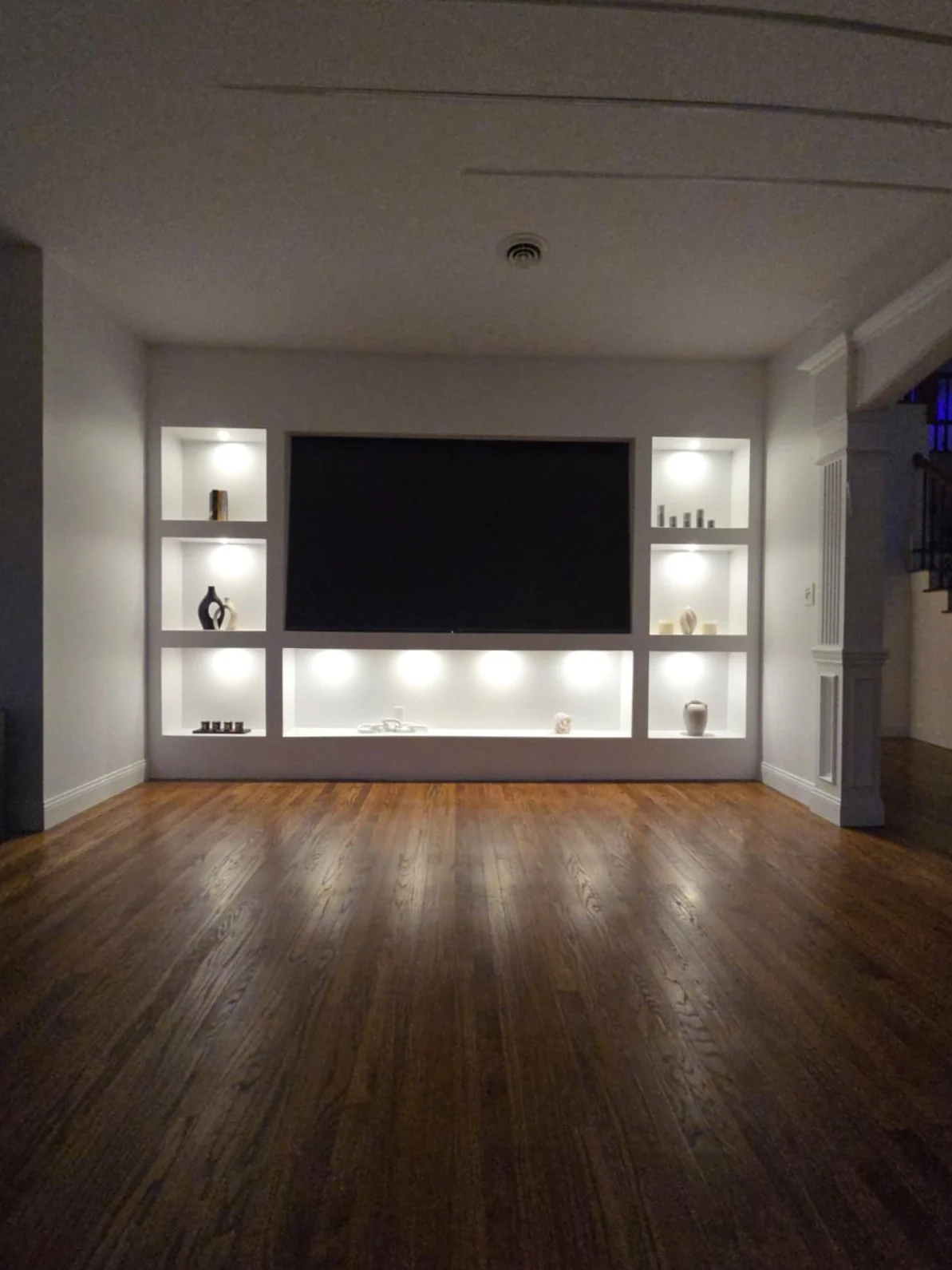 Media wall with individually illuminated display niches