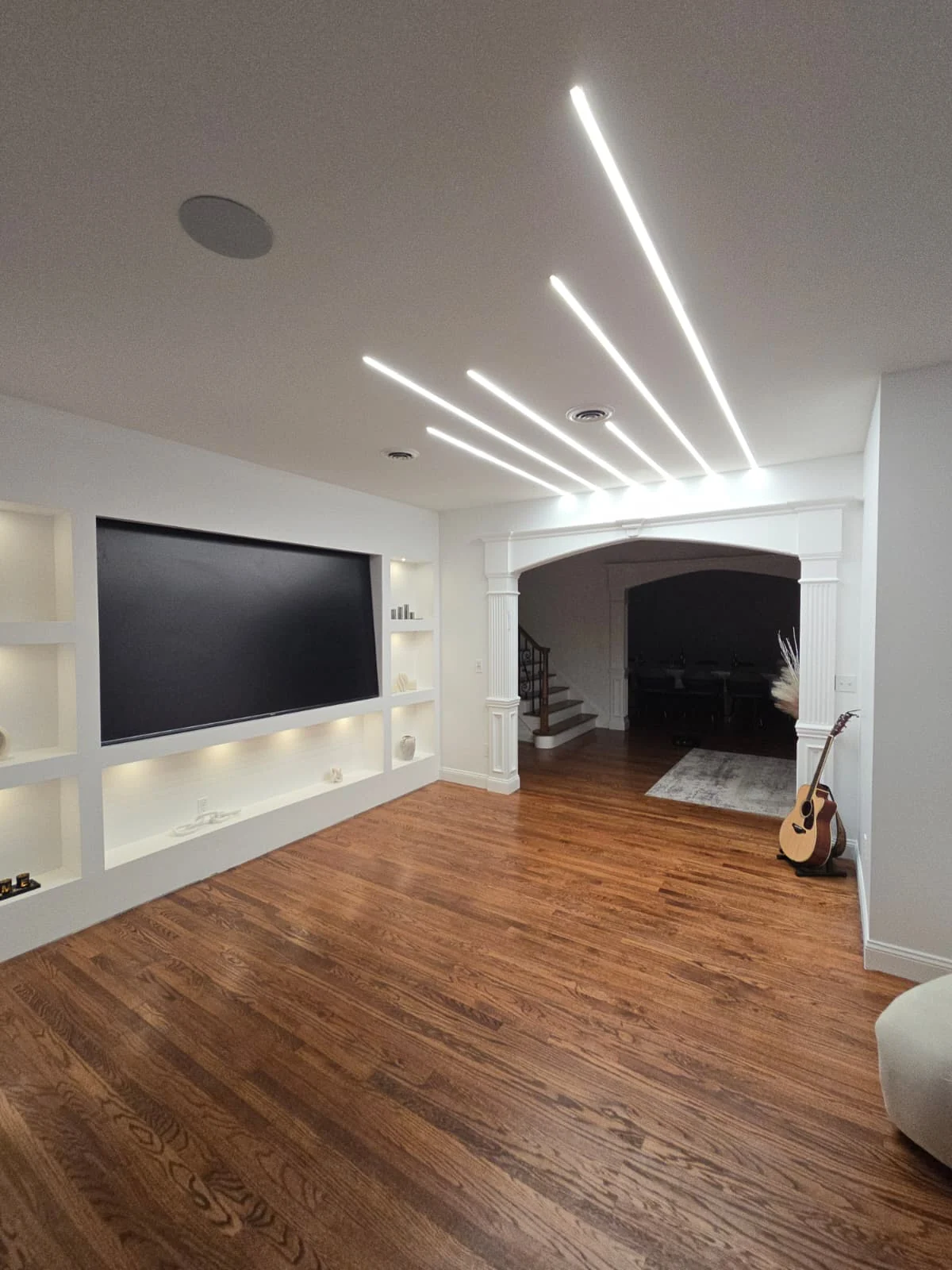 Residential room with recessed linear LED ceiling lights