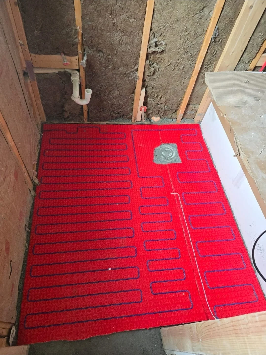 Radiant floor heating tubing installed in a bathroom